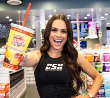Woman holding a One Stop Nutrition smoothie cup