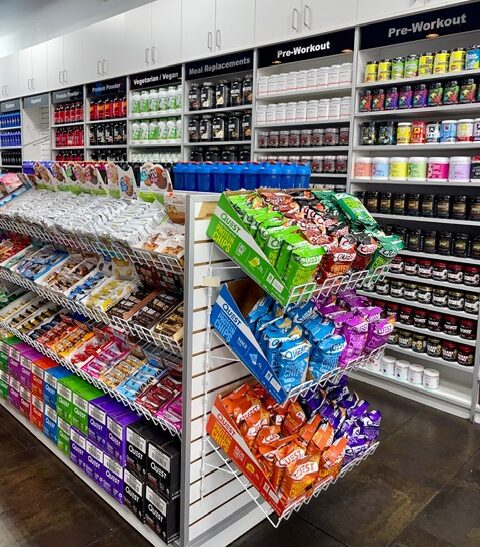 Interior view of organized supplement displays and wellness products inside a One Stop Nutrition store