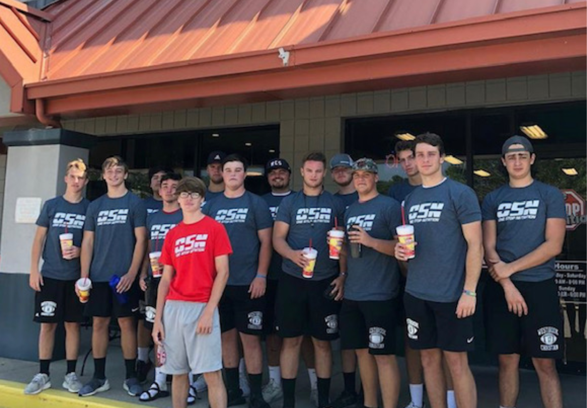Group standing in front of a One Stop Nutrition store